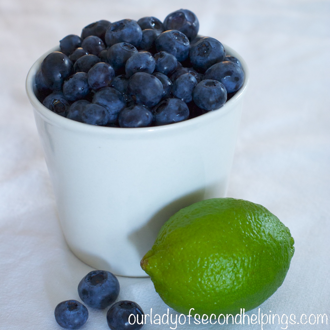 Cup of blueberries and a lime